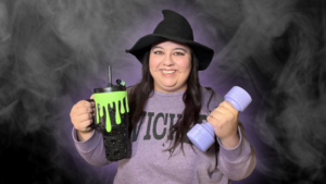 mandy spooks getting healthy for halloween with a witch hat, purple dumbbell, and spooky water tumbler